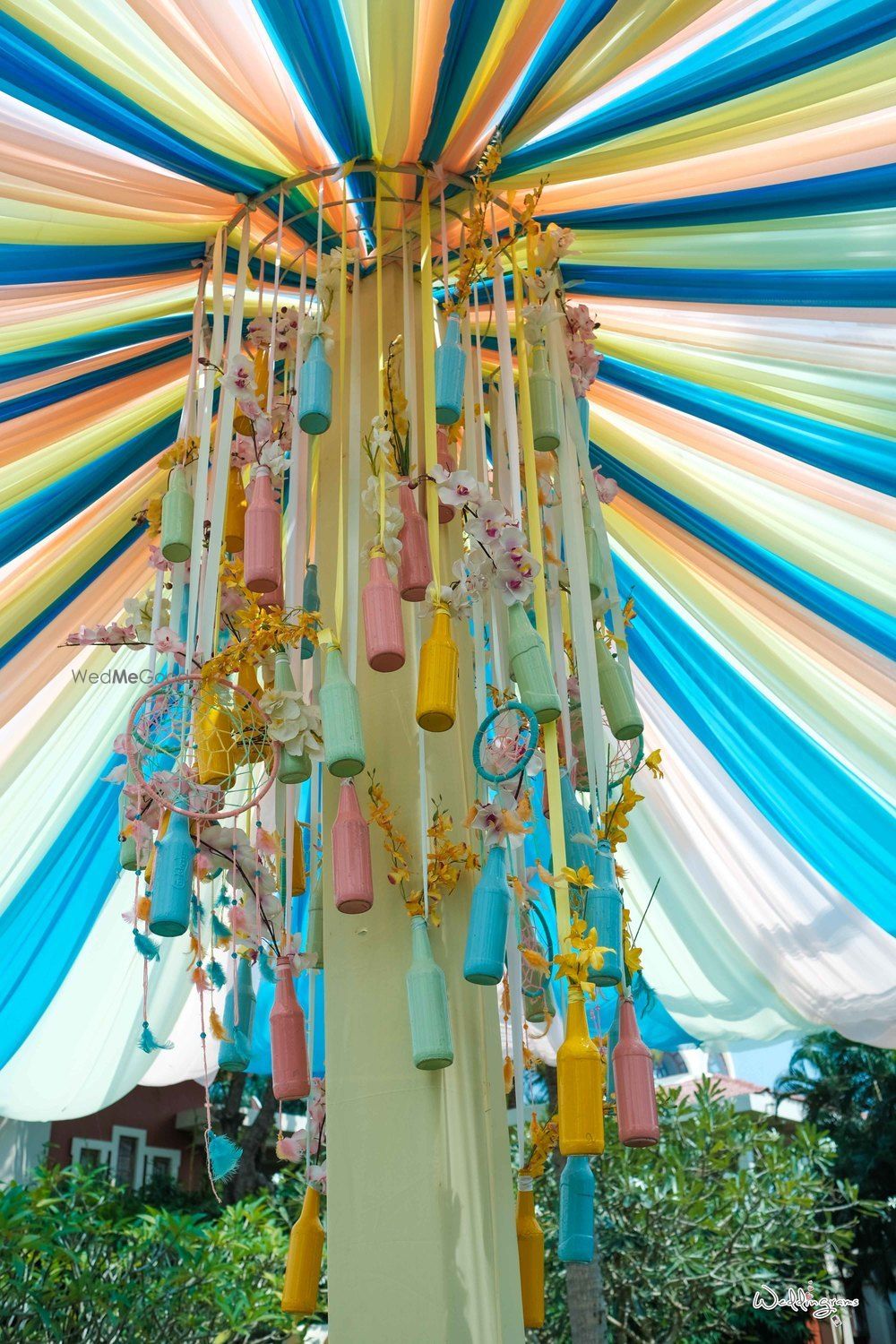 Photo of Mehendi decor idea with painted bottle chandelier