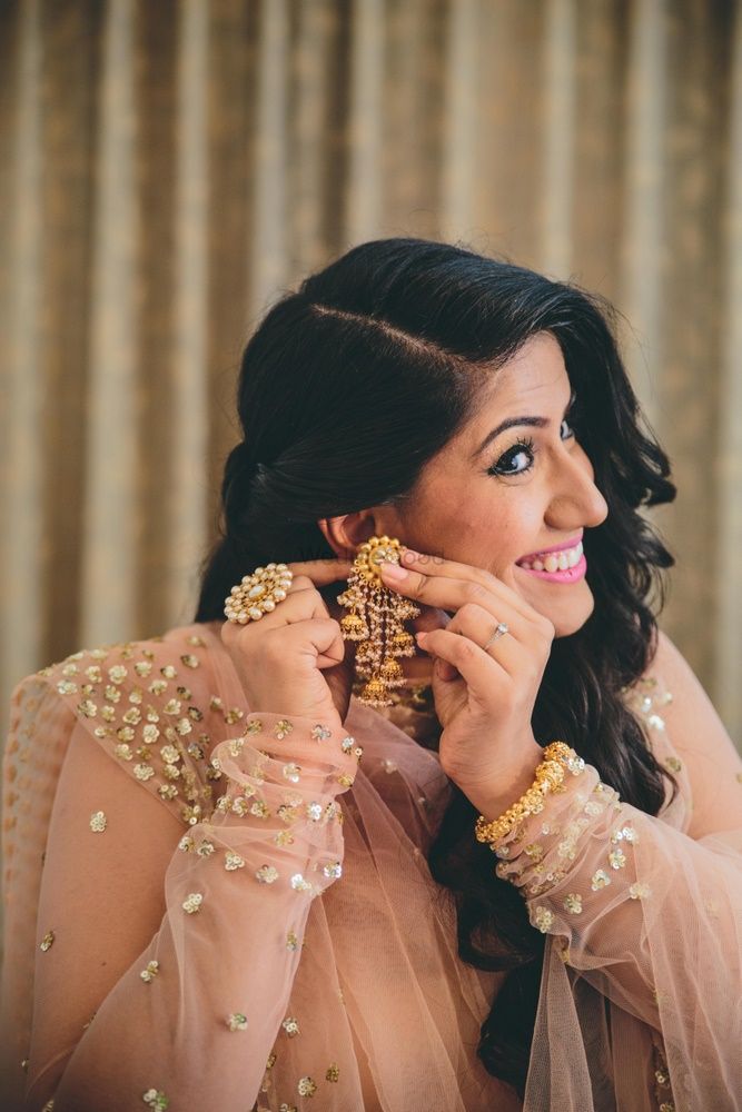 Photo of Unique earrings as bride gets ready