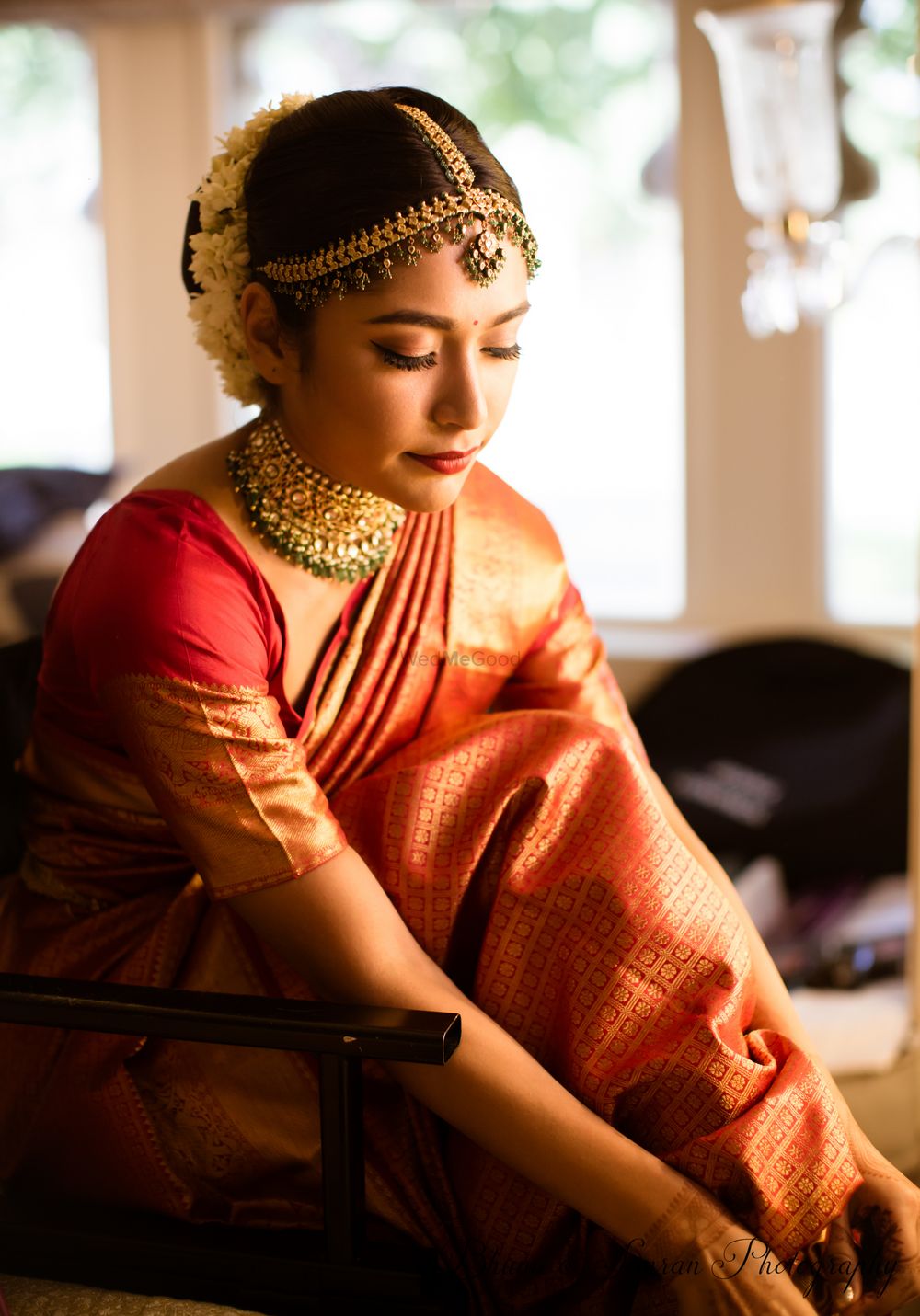 Photo of South Indian bride getting ready portrait in orange saree