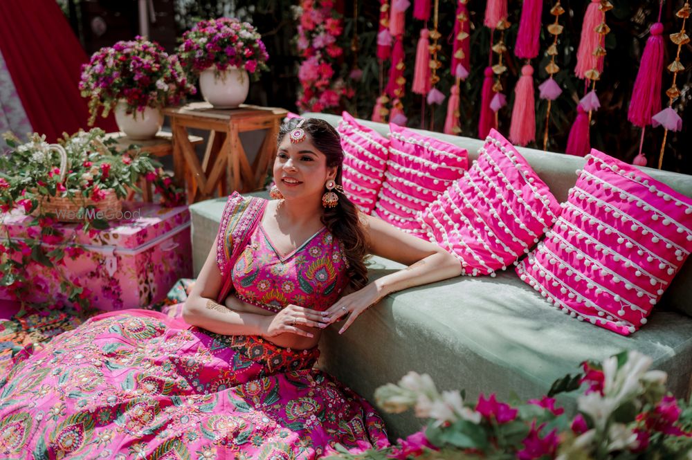 Photo of Bridal shot in front of her beautiful and vivid bridal seating on her Mehendi day.