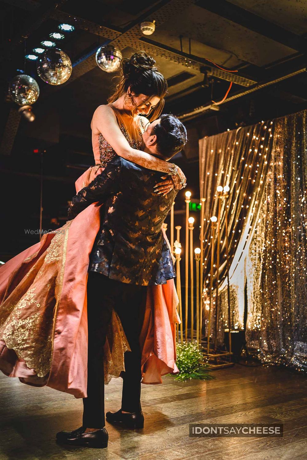 Photo of Groom holding the bride in his hands.