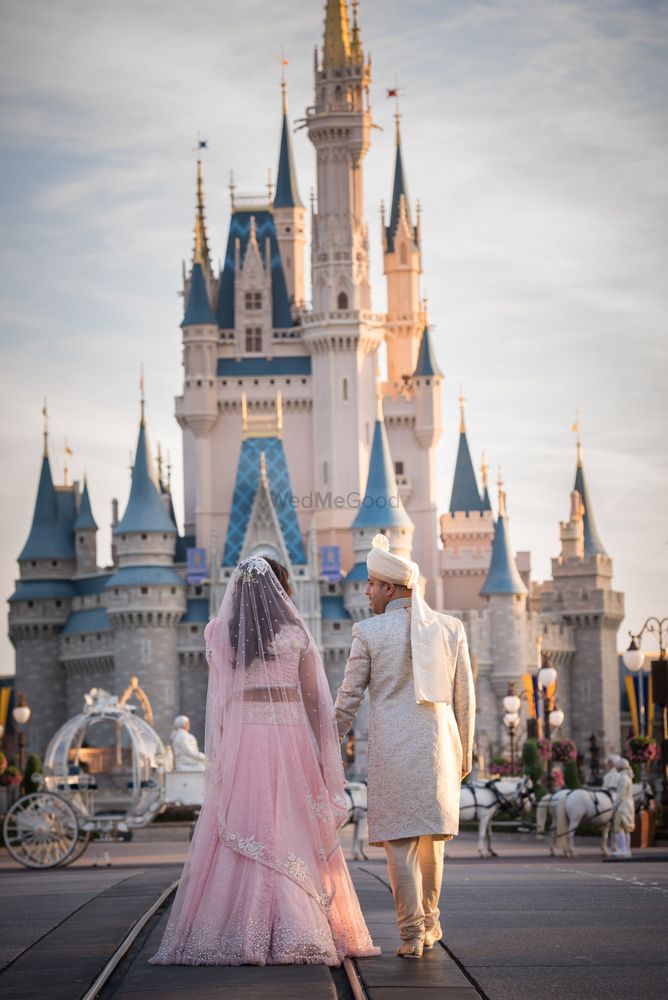 Photo of Bride and groom pose infront of Disney World castle at Orlando