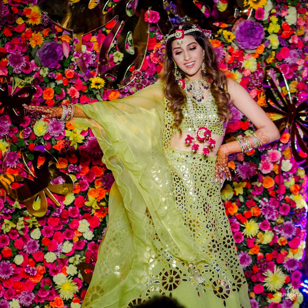 Photo of The bride in a stunning lime green lehenga for her mehendi