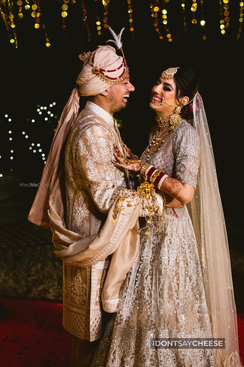 Photo of A happy couple laughing their heart out at their wedding.