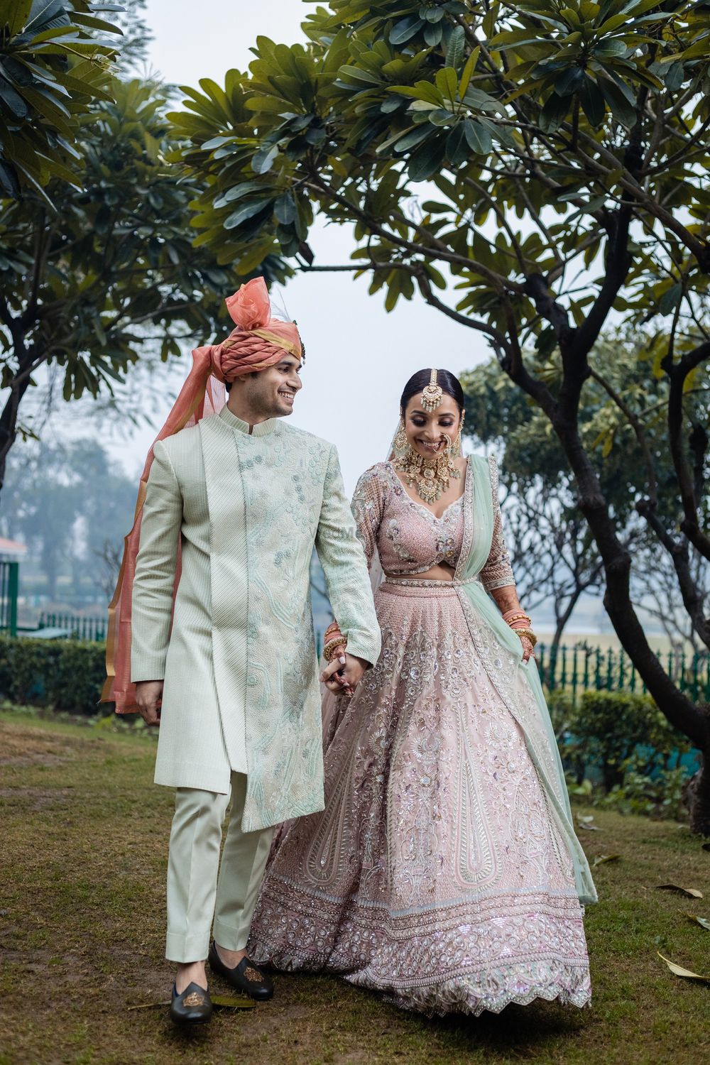 Photo of pretty couple photo with both bride and groom in pastel outfits