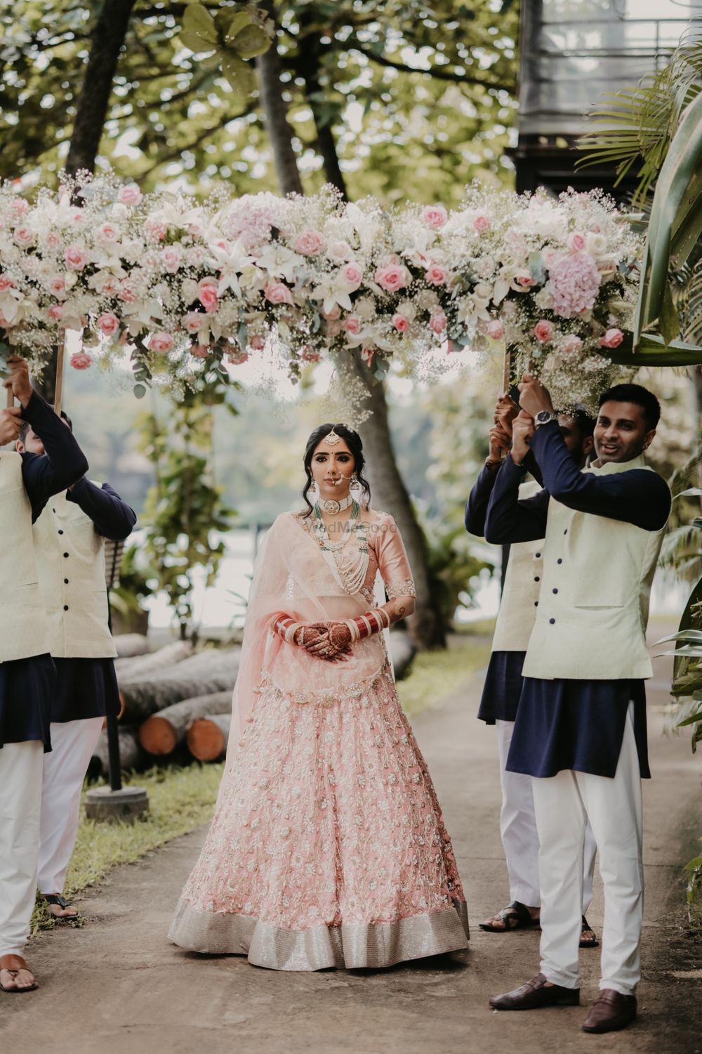 Photo of pastel bride under floral phoolon ki chadar