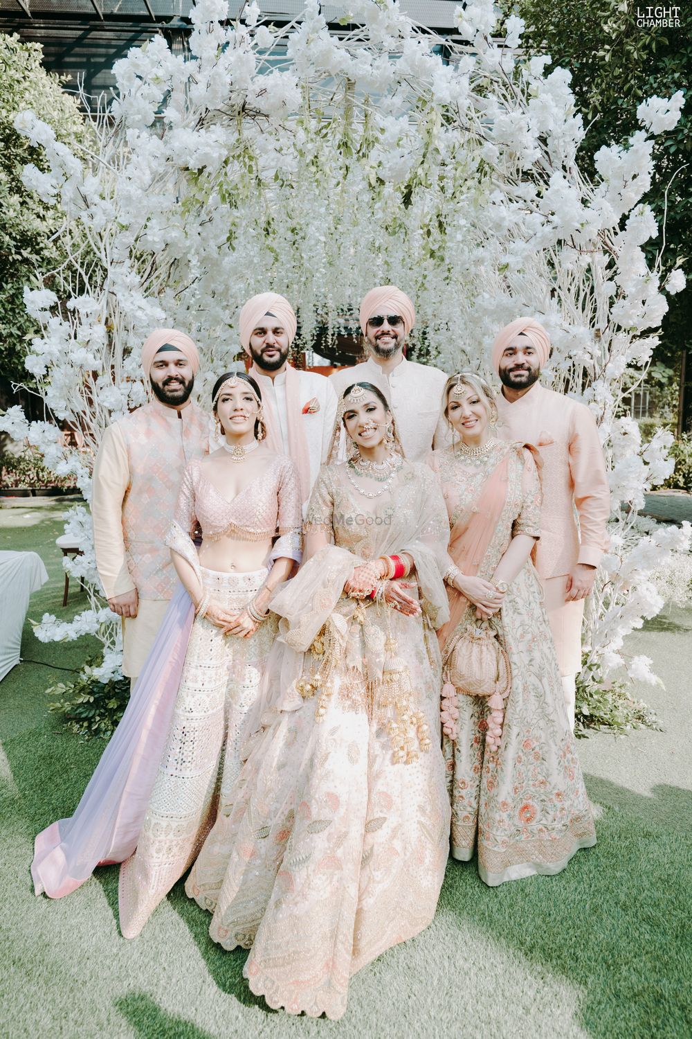 Photo of sikh bridal family portrait in coordinated outfits