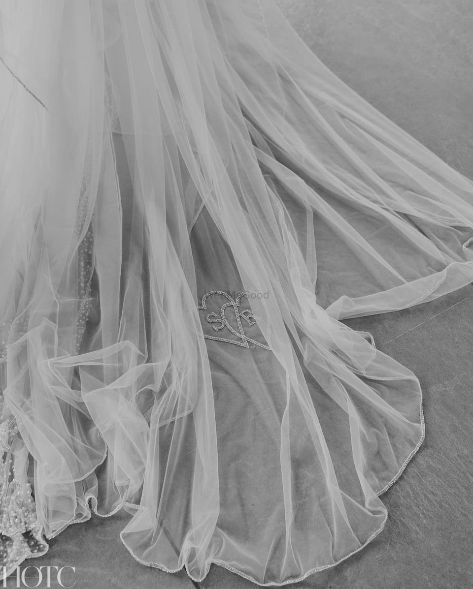 Photo of Personalized veil shot with bride and groom initials embroidered on it.