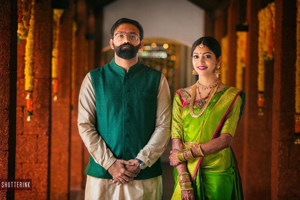 Photo of Coordinated South Indian bride and groom in green