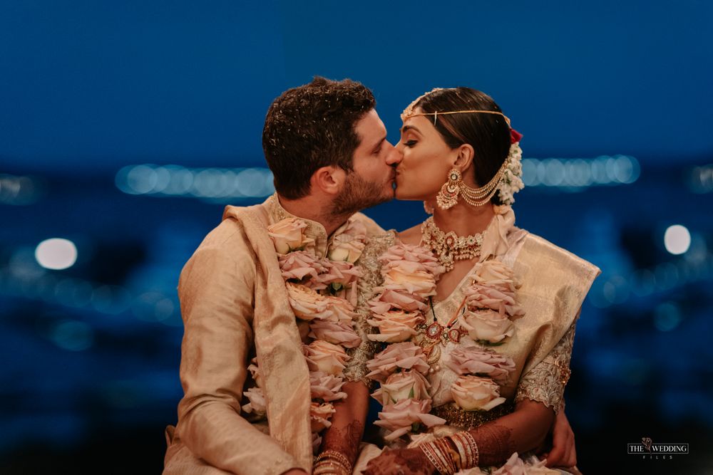 Photo of groom kissing the bride at the mandapam shot