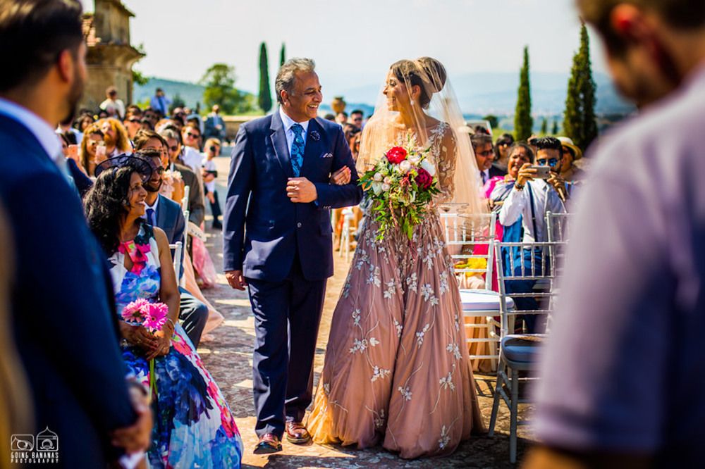 Photo of Offbeat bride in peach gown entering with her father