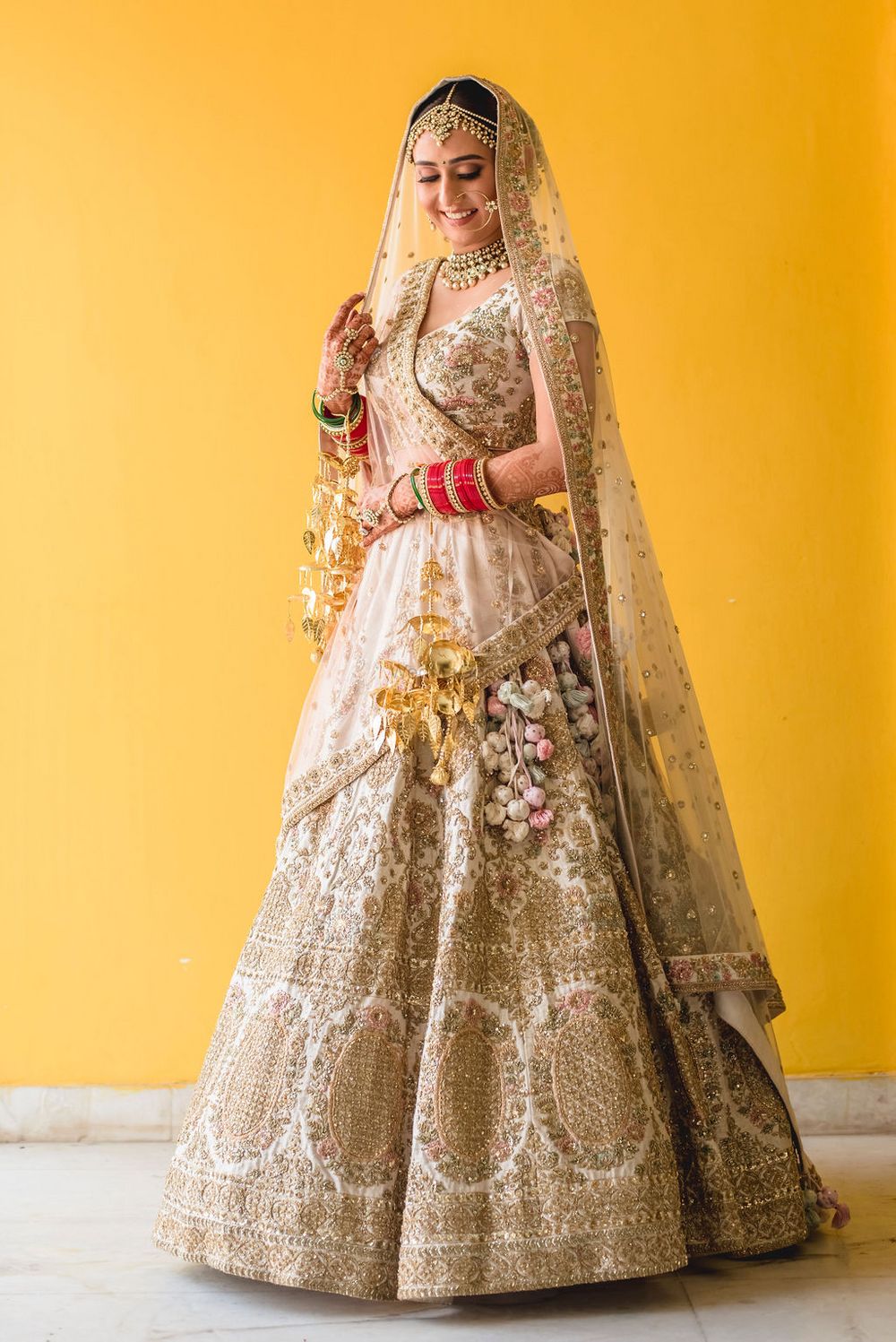 Photo of White and gold bridal lehenga with double dupatta