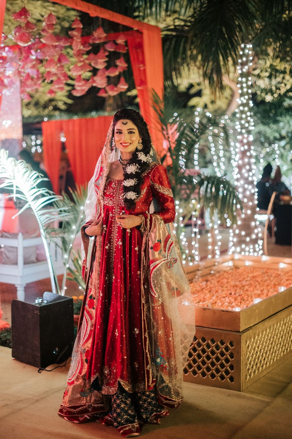 Photo of Bride dressed in a unique mehndi outfit with a braided hairdo.