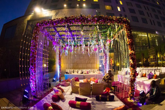 Photo of shrubery flower mandap with hanging florals