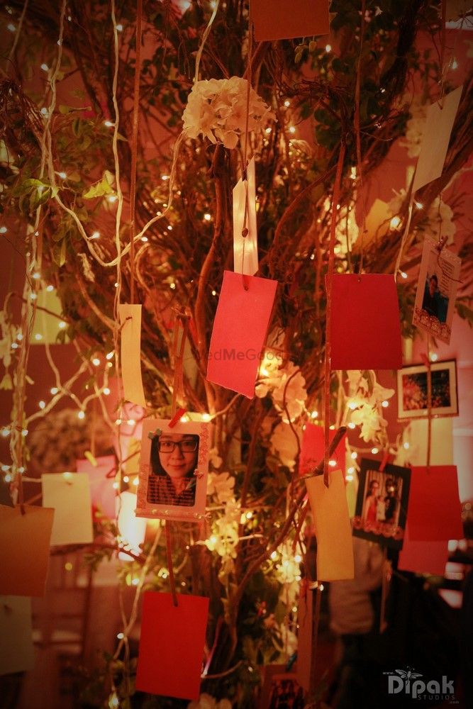 Photo of Indoor Wishing Tree with Suspended Lights and Photos