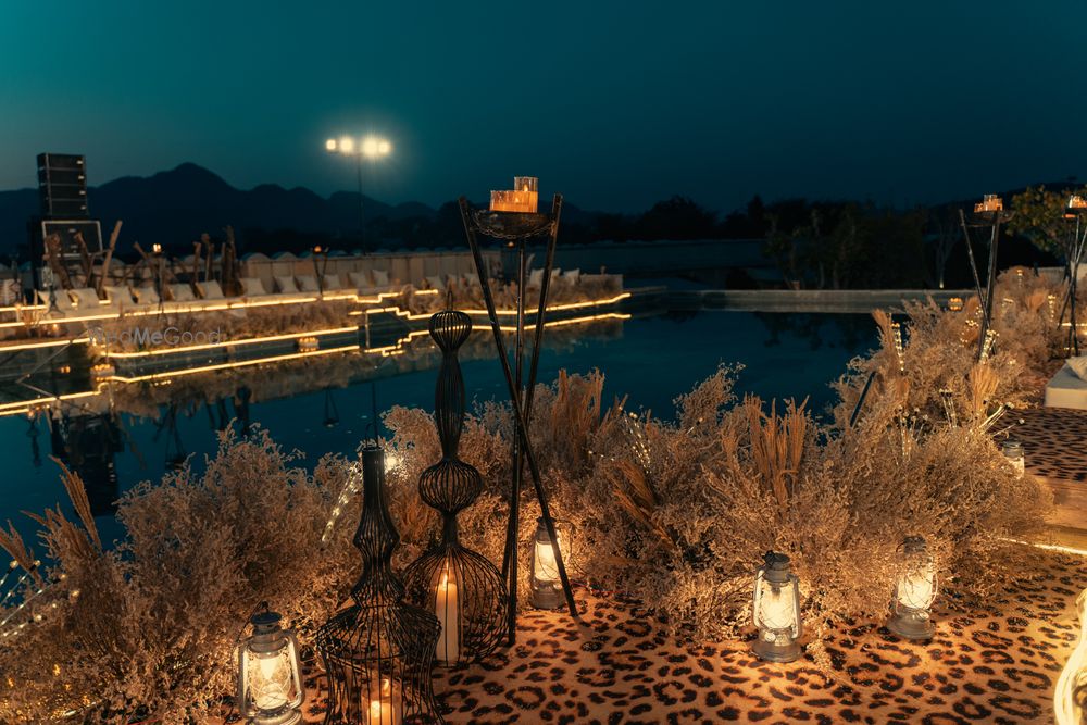 Photo of Rustic decor with leopard print elements and lamps for a pre-wedding outdoor event