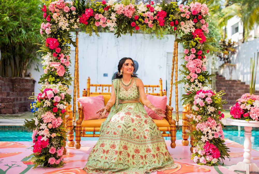 Photo of Bride on a floral swing for mehendi