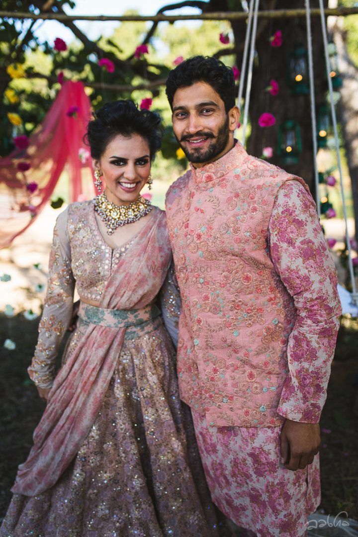 Photo of Bride in Sabyasachi with floral dupatta and waist belt