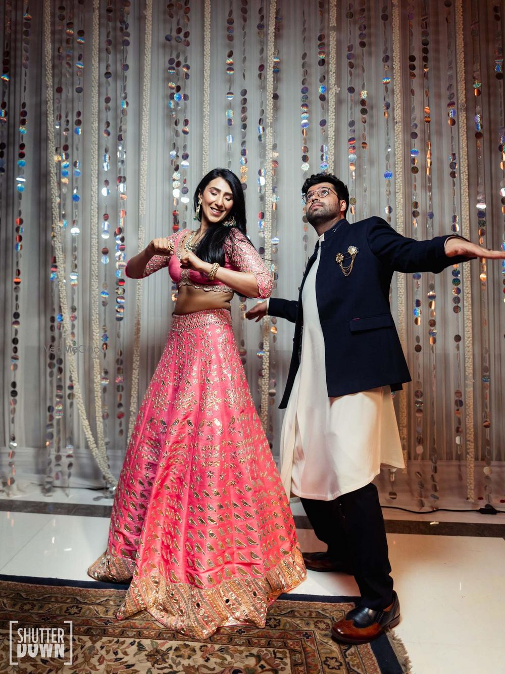 Photo of Bride in a pink mirrorwork lehenga for the Mehndi