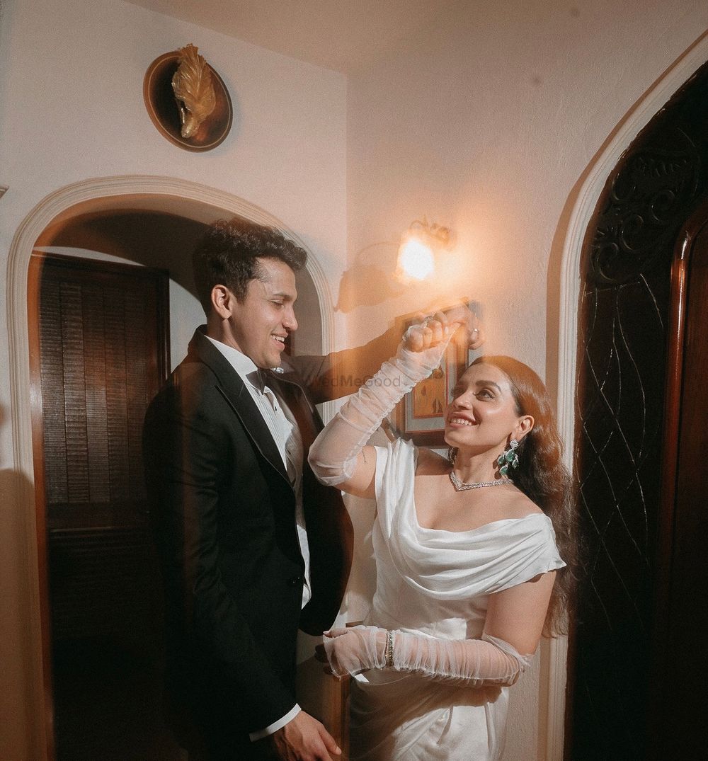 Photo of Gorgeous capture of the couple in a black tuxedo and white off shoulder gown