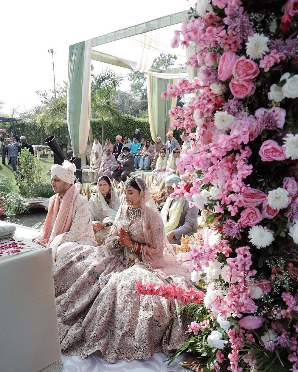 Photo of Serene shot of the couple at their anant karaj with lovely floral decor