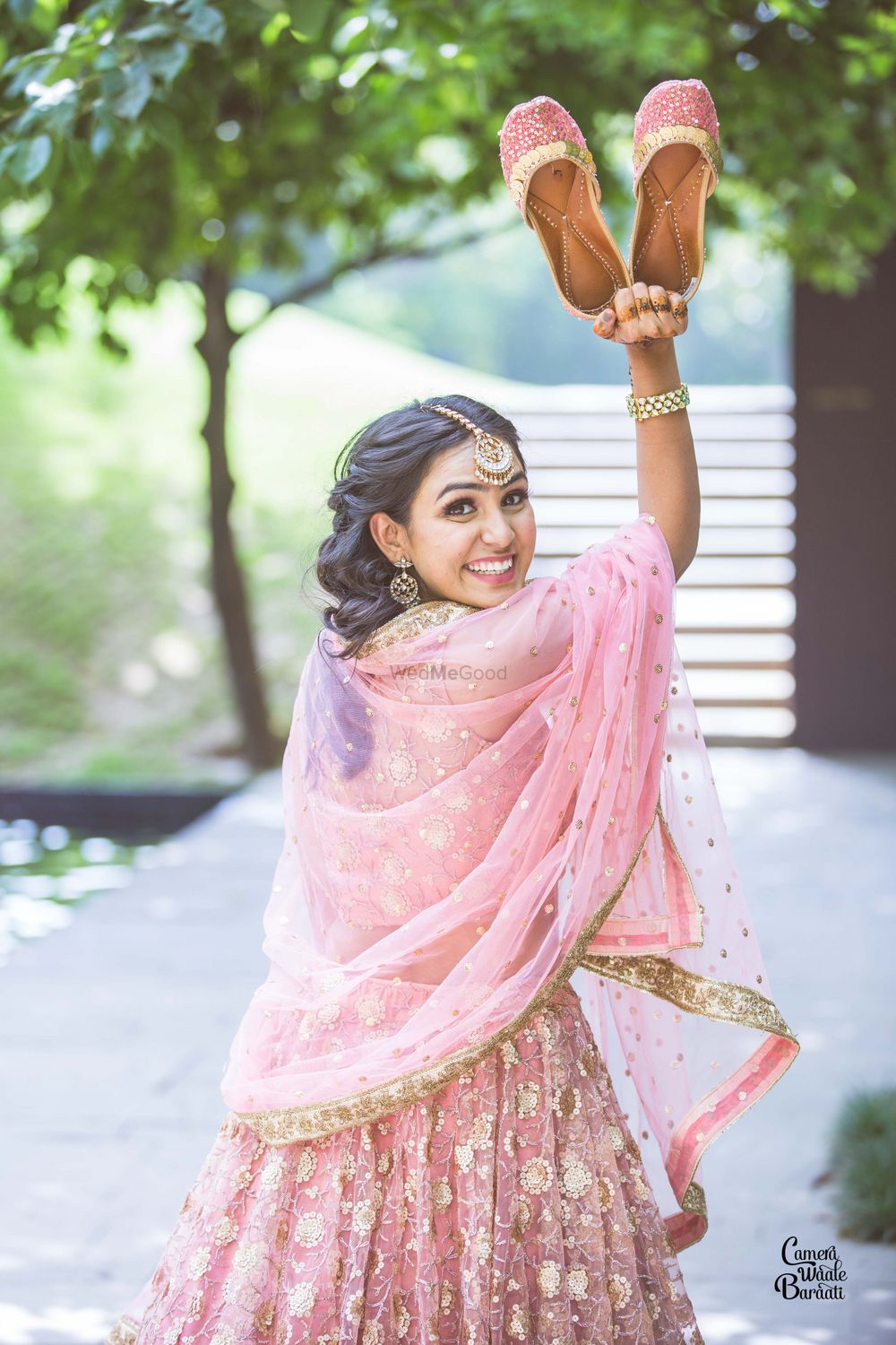 Photo of A bride to be in a baby pink outfit for her mehndi