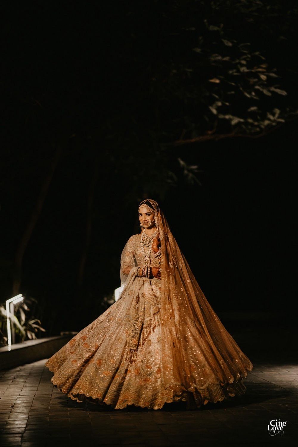Photo of Bride twirling in a dull gold lehenga