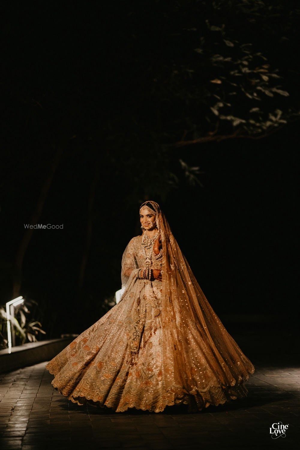 Photo of Bride twirling in a dull gold lehenga