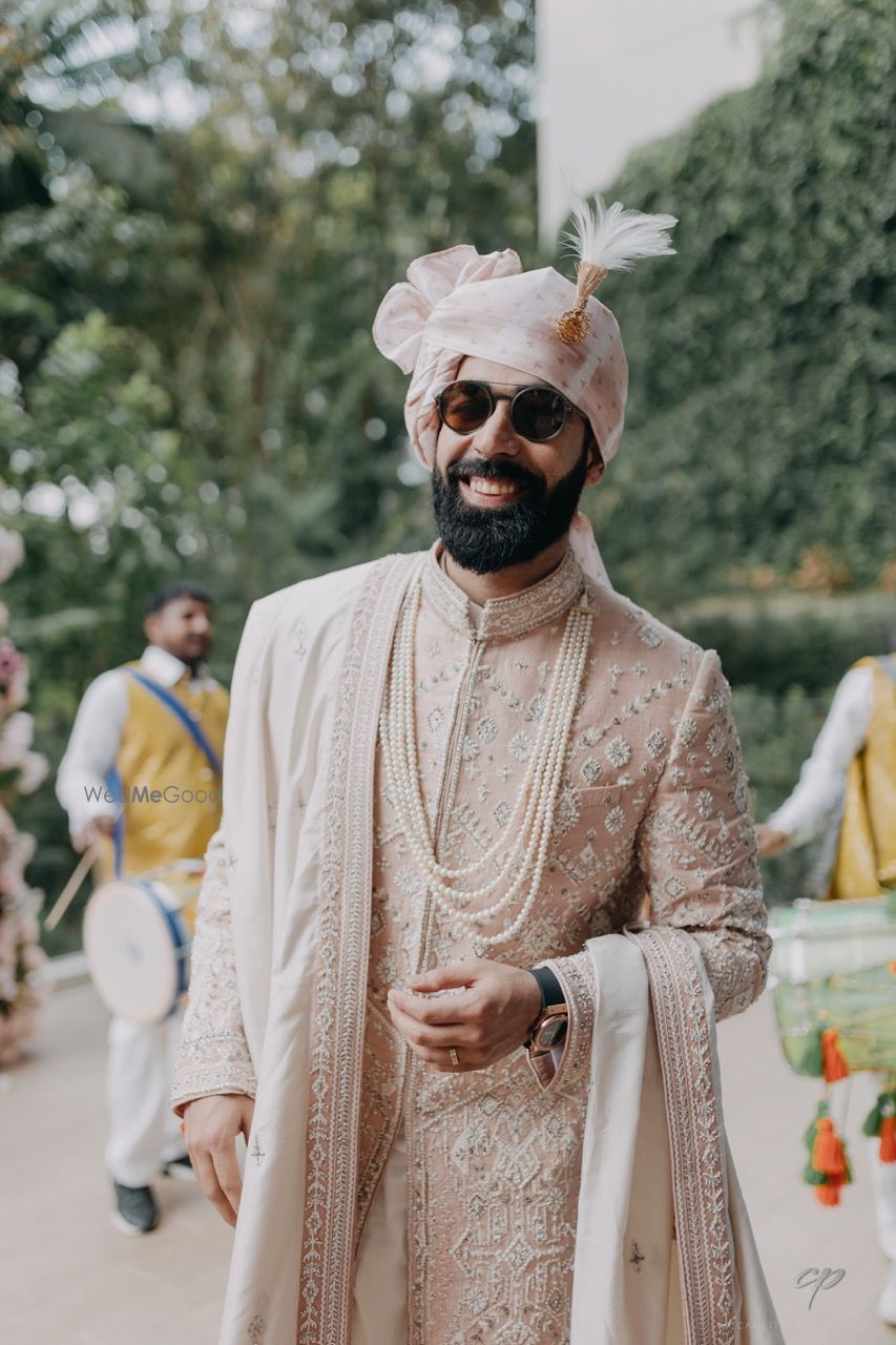 Photo of Unique peach sherwani with pearl jewellery for the groom to be on his wedding day