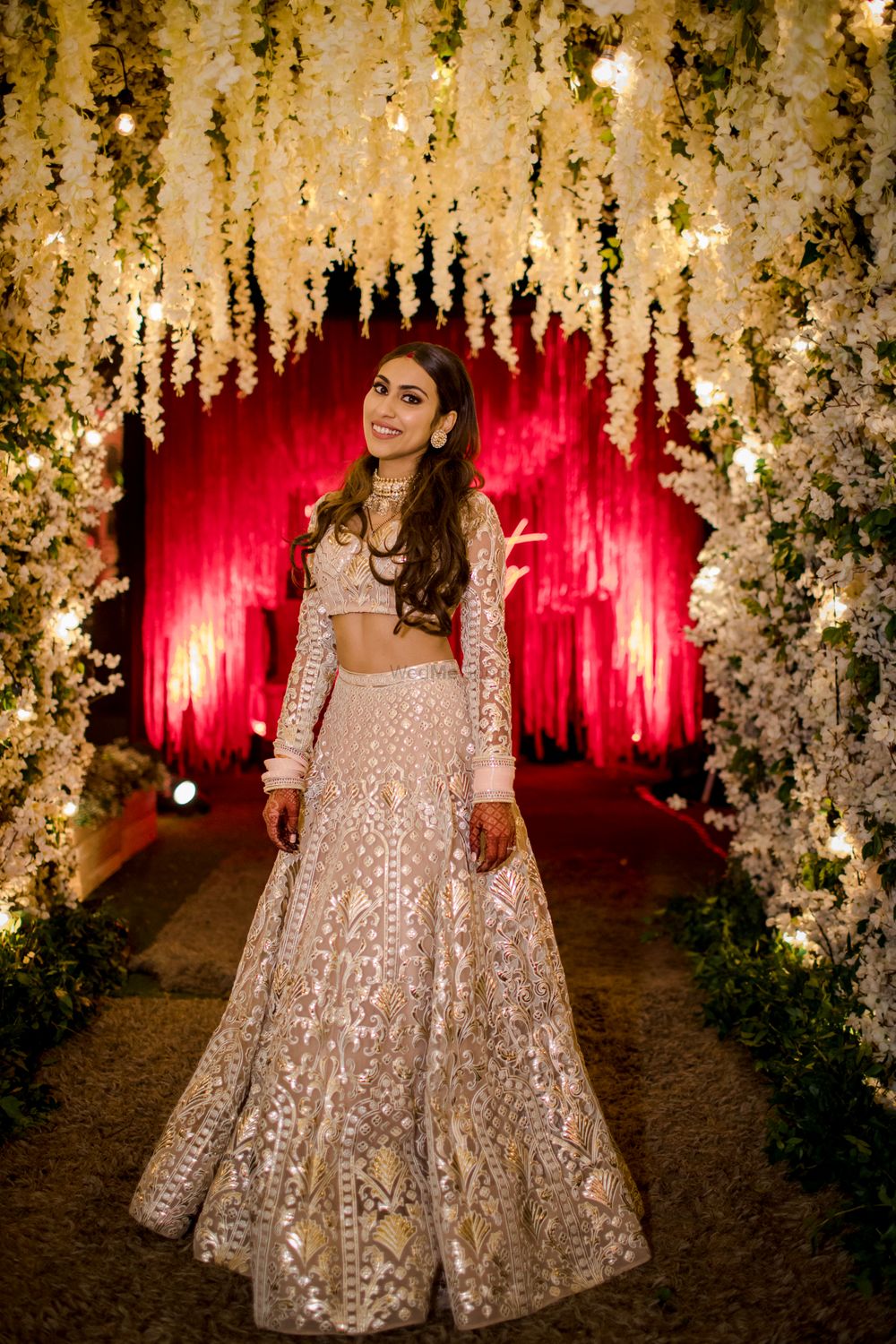 Photo of Bride dressed in an ivory & silver lehenga for the reception.