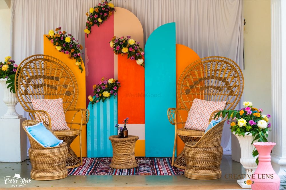 Photo of Cane chairs with colourful installations.