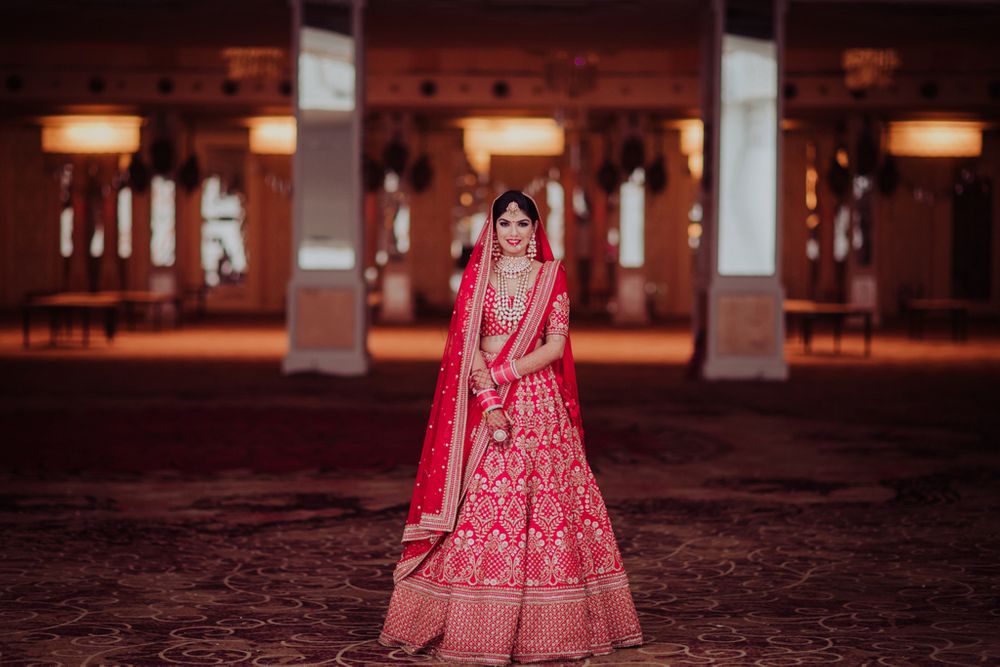 Photo of A bride in a red lehenga and double dupatta for her wedding
