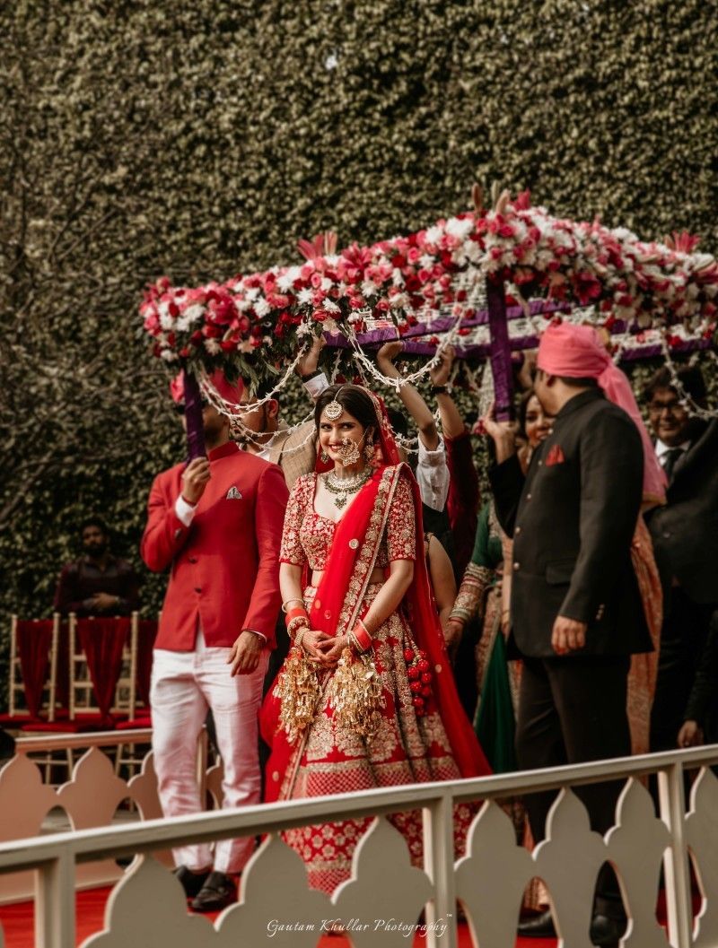 Photo of Bride entering under matching phoolon ka chadar