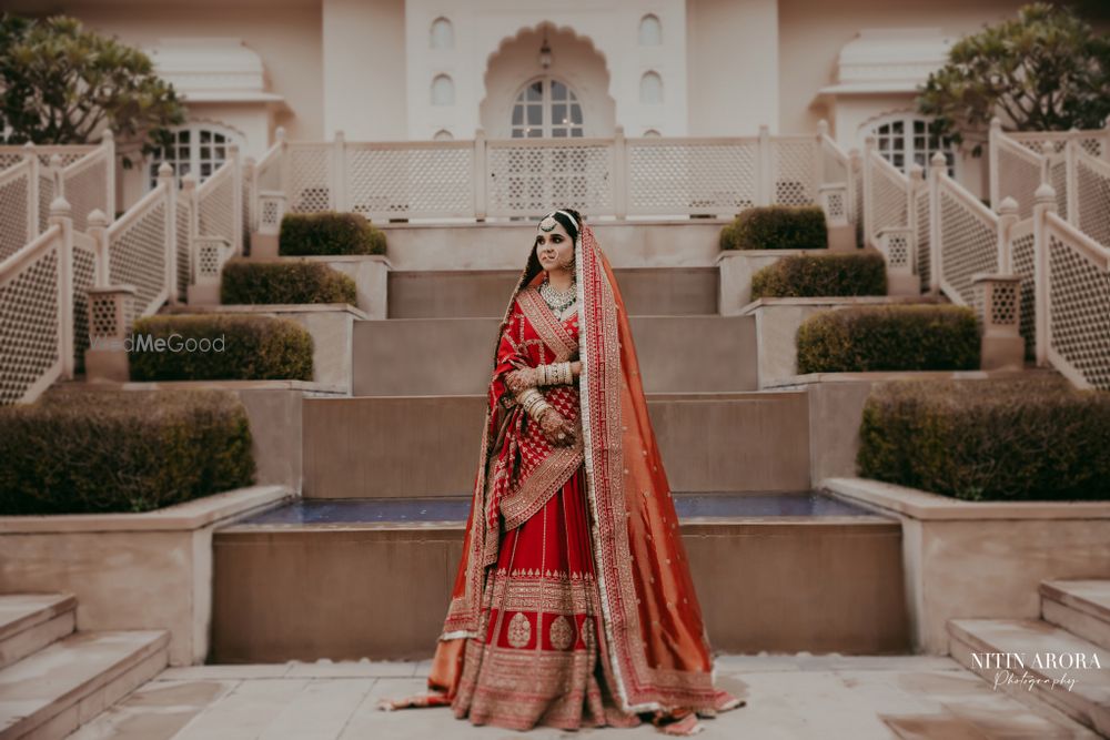 Photo of bride in red and gold sabyasachi lehenga