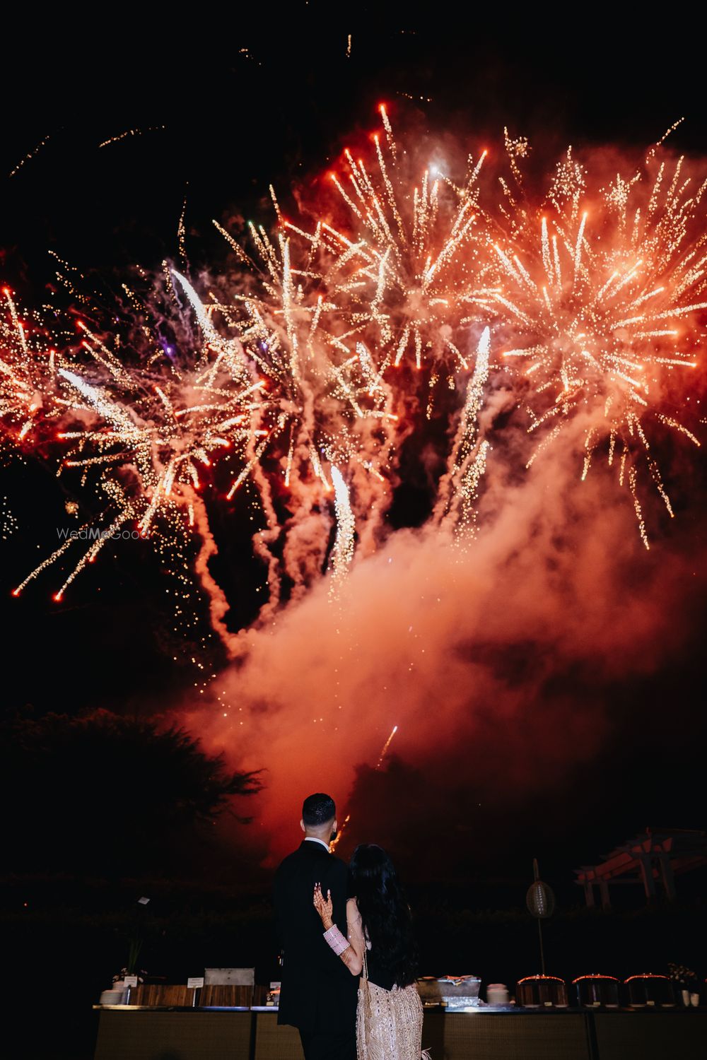 Photo of Gorgeous shot of the couple with statement fireworks at the background