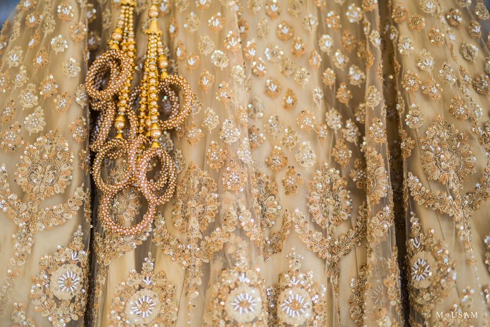 Photo of unique bridal lehenga tassels for gold lehenga