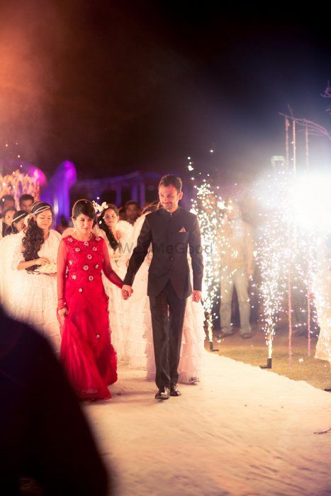 Photo of bride and groom entry with sparklers