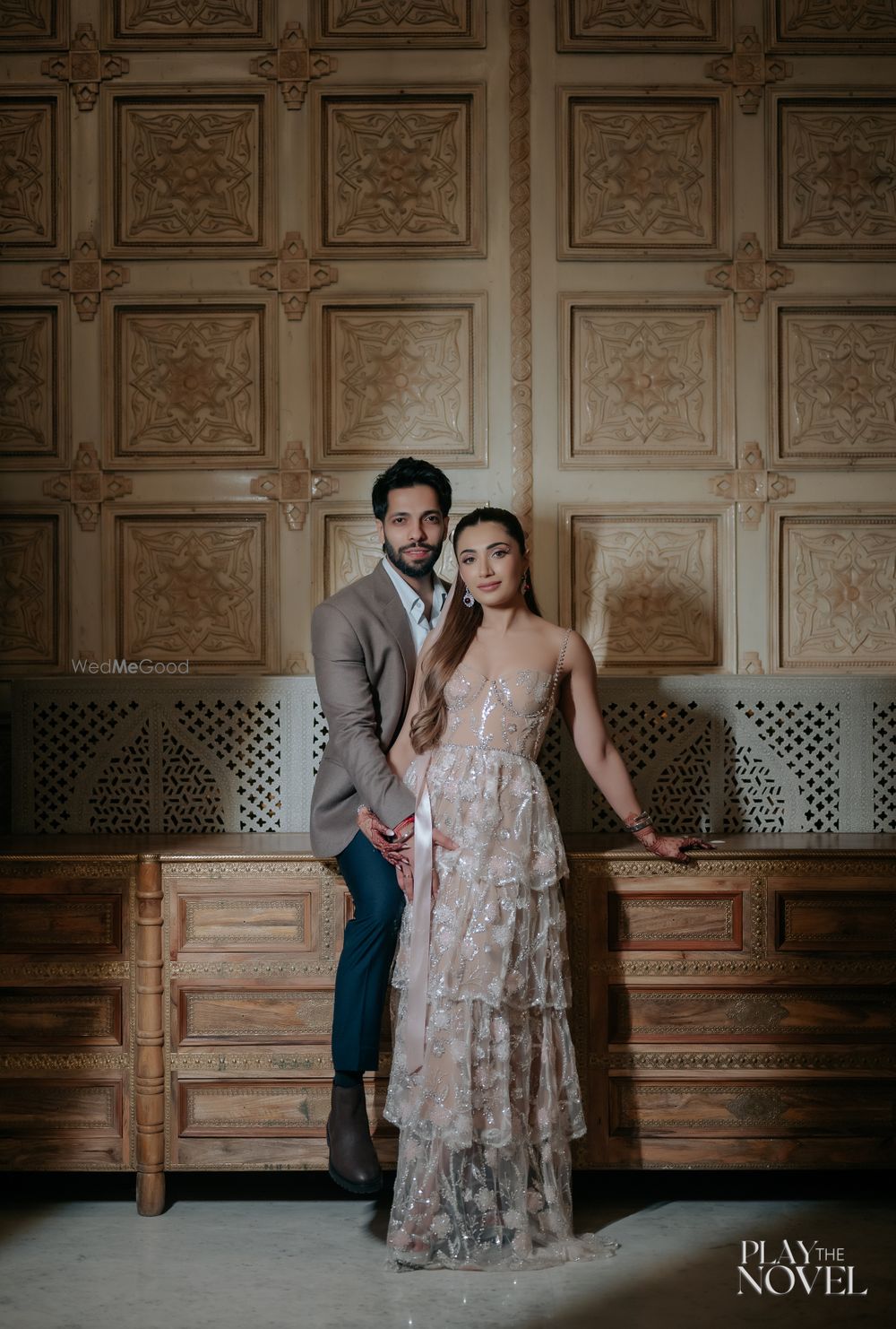 Photo of Lovely shot of the bride and groom with the bride in a nude shimmery gown and the groom in a earthy tone blazer