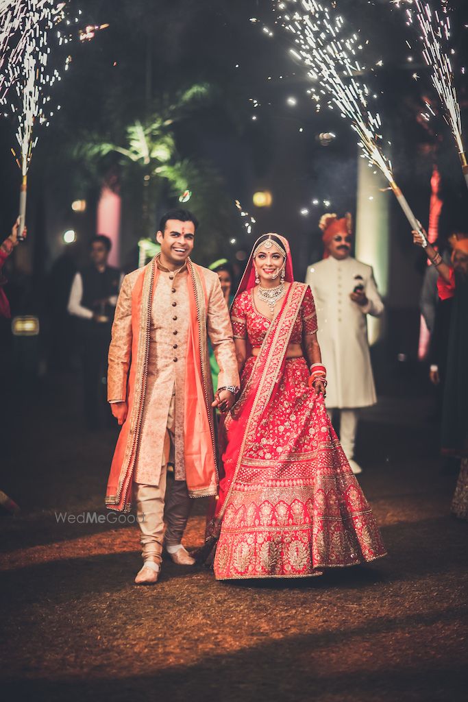 Photo of Couple entry idea on wedding with guests holding cold pyros