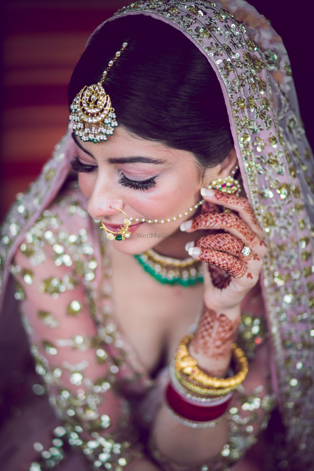 Photo of A pretty shot of the bride's subtle and light makeup with bold eyes.
