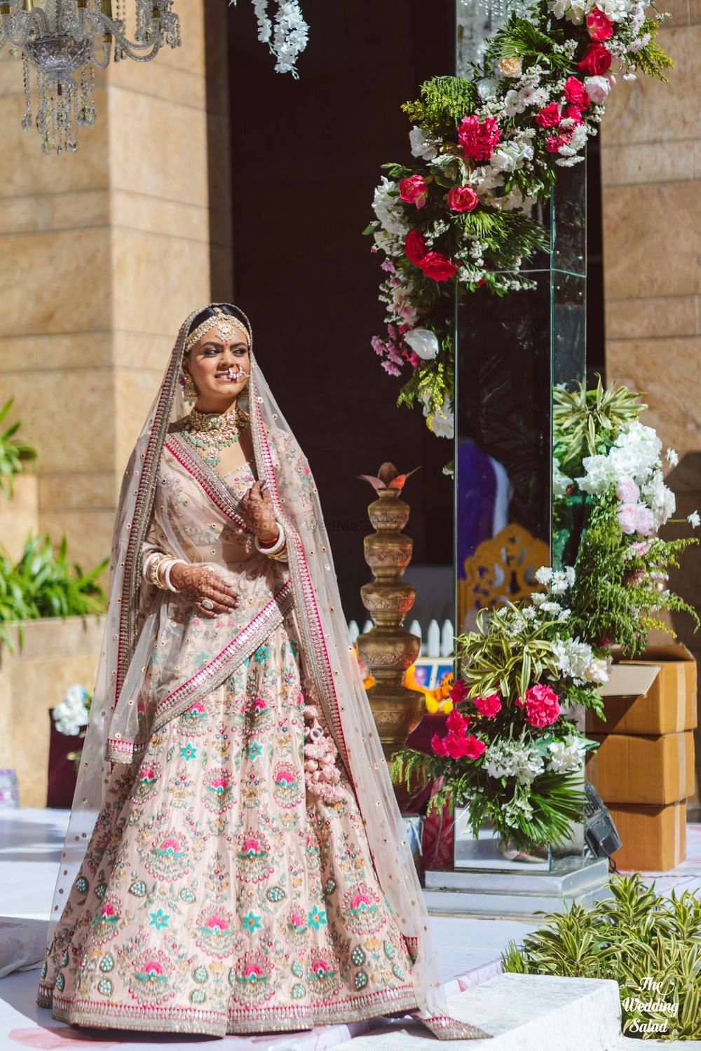 Photo of bride in a pastel pink sabyasachi lehenga with floral motifs