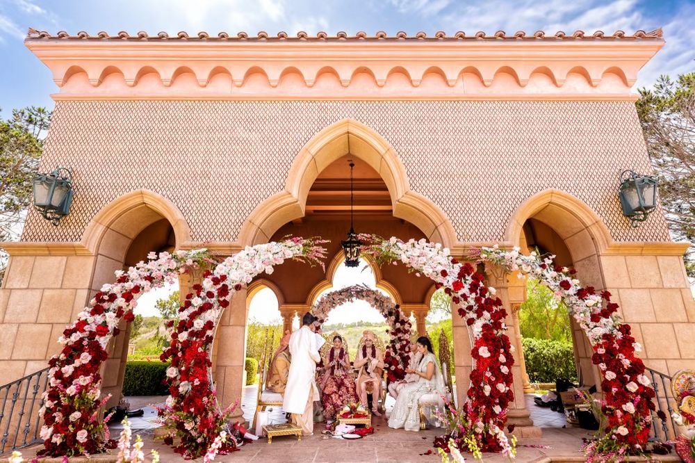 Photo of unique circular floral mandap idea with maroon and white flowers