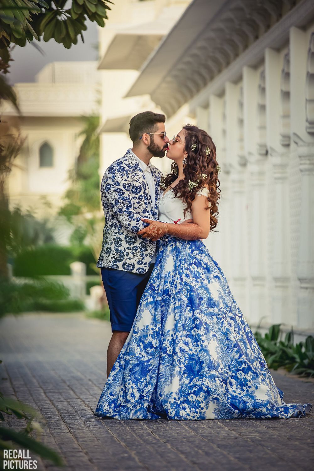 Photo of Twinning bride and groom kissing on mehendi