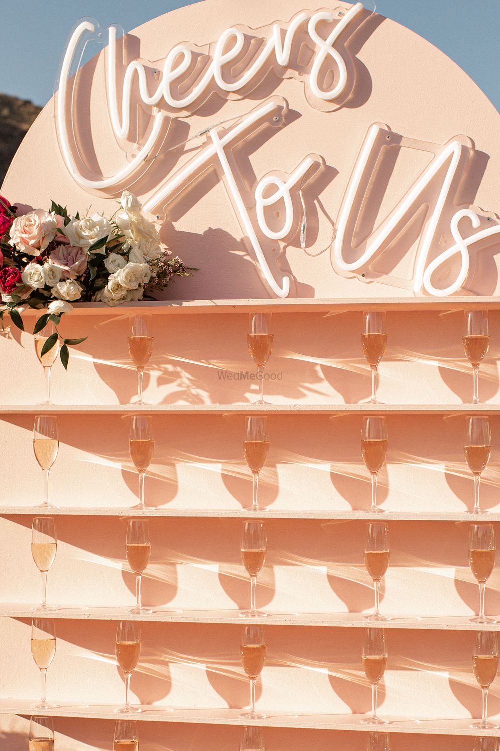 Photo of cute champagne favour wall for entrance decor in mehendi