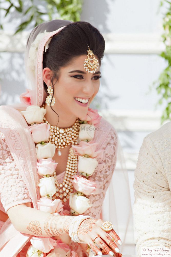 Photo of Happy bride shot with matching pastel jaimala