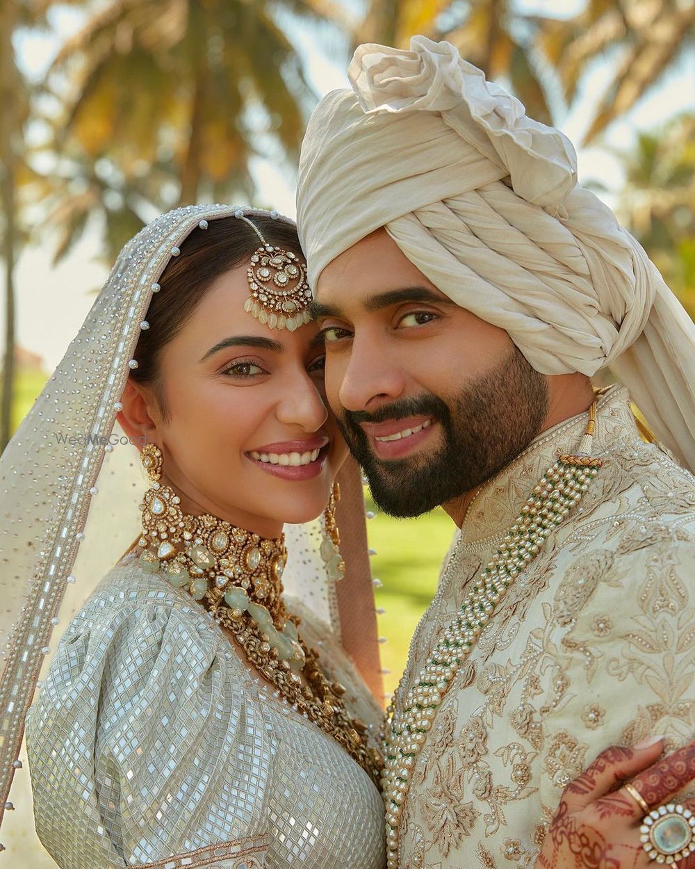 Photo of Lovely couple shot in all-white ensembles for a day wedding