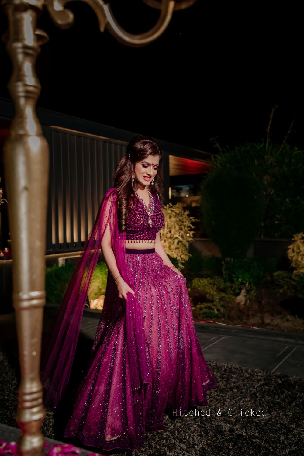 Photo of A bride in a wine coloured lehenga on her pooja