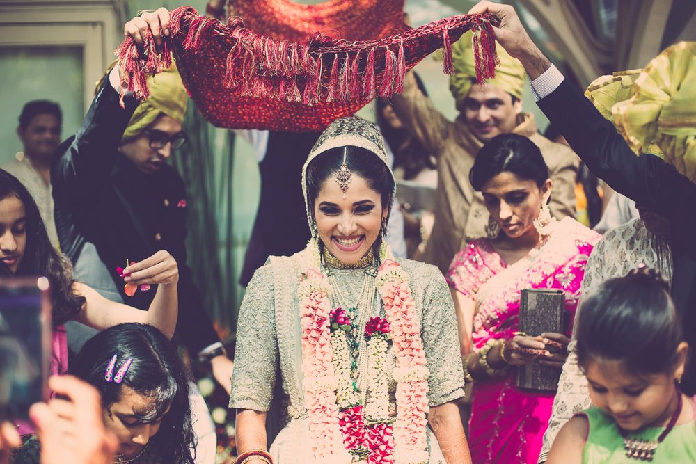 Photo of bridal entry under a dupatta