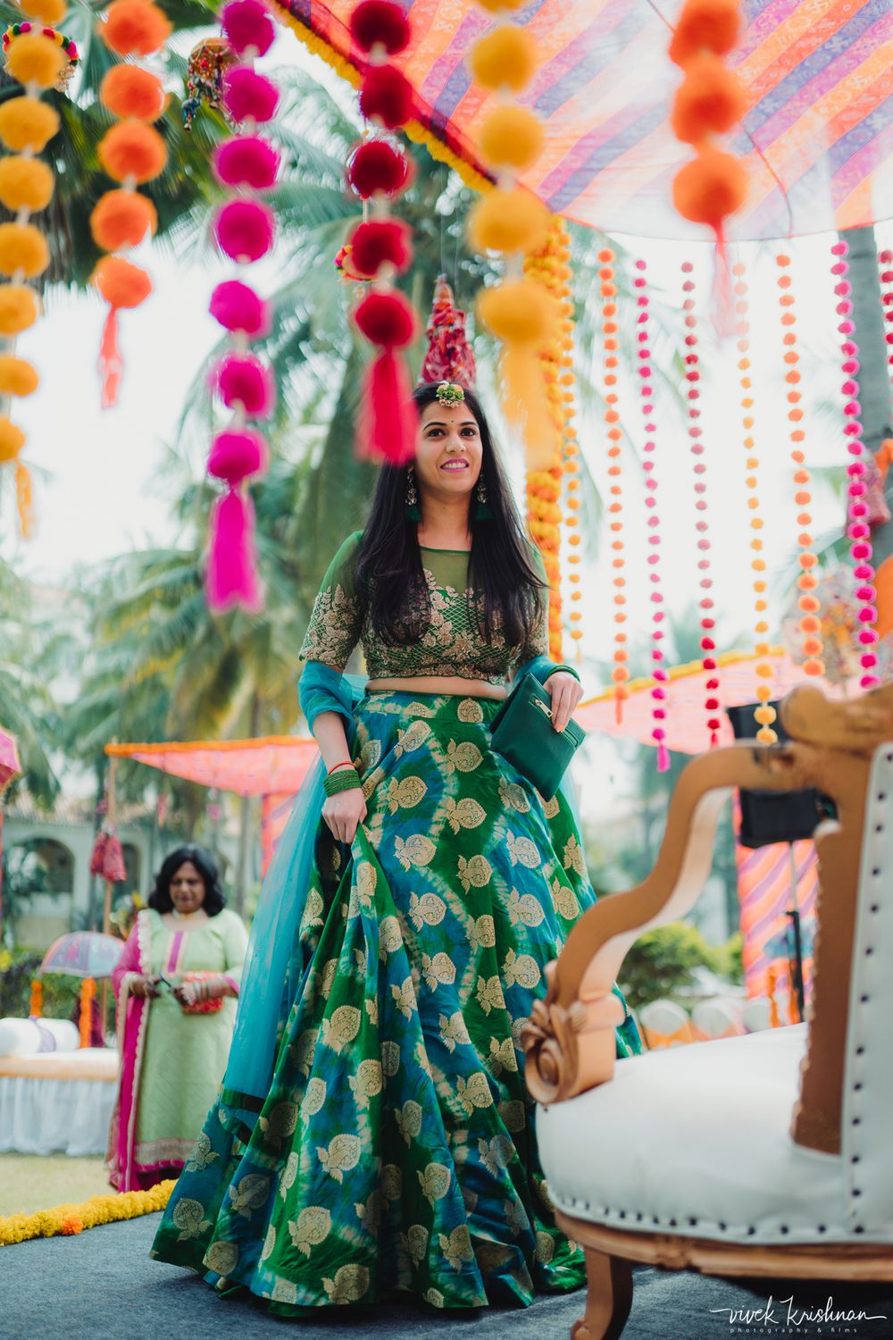 Photo of Bride wearing a dark green lehenga on her mehendi day