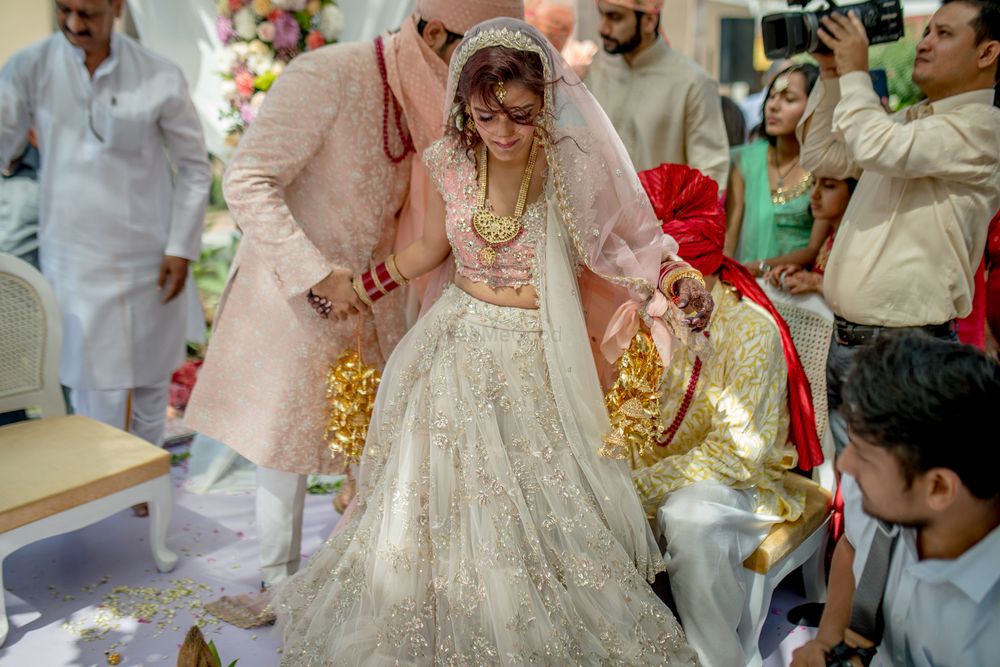 Photo of A beautifully candid shot of the bride and groom during the pheras!